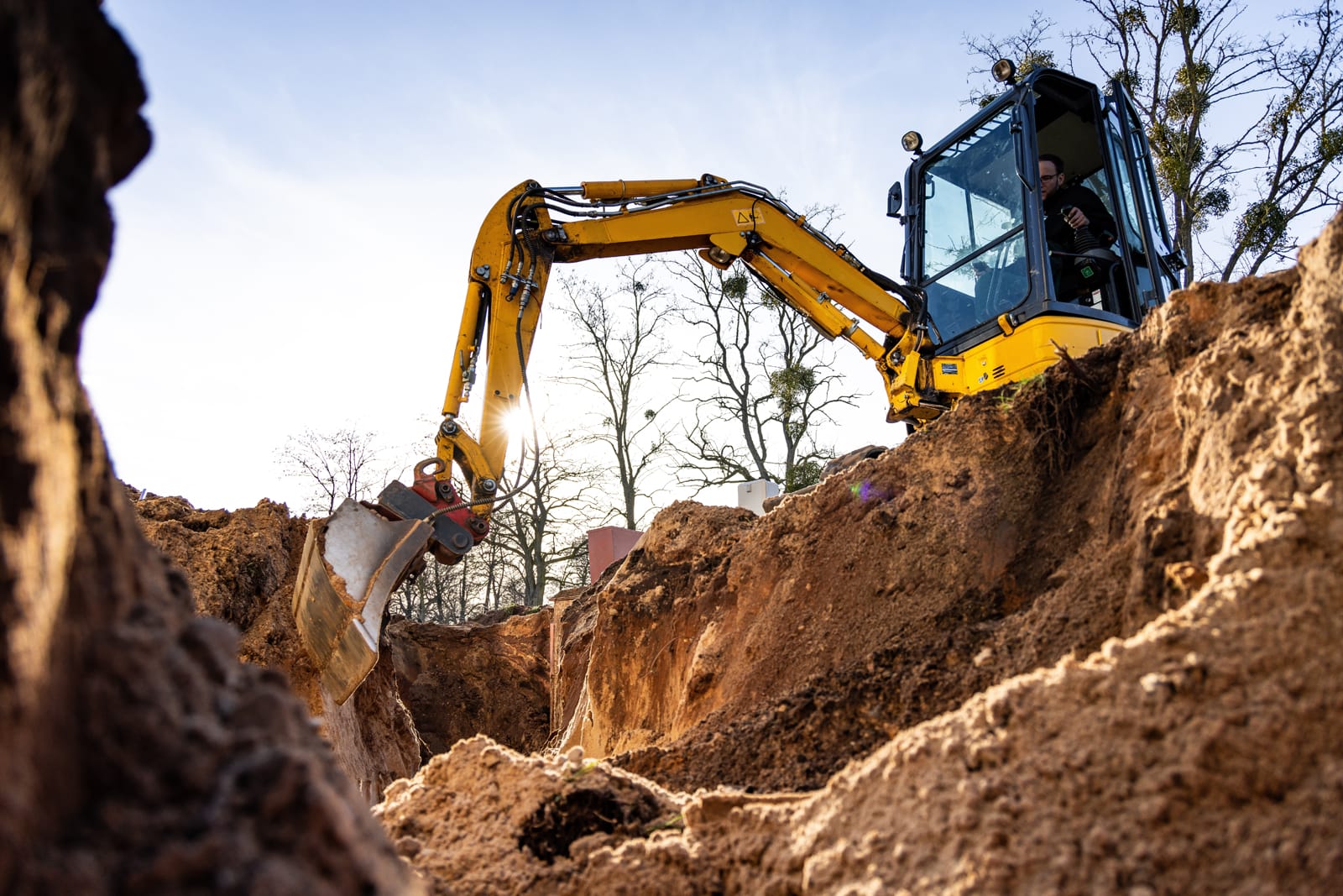 Excavator digging land